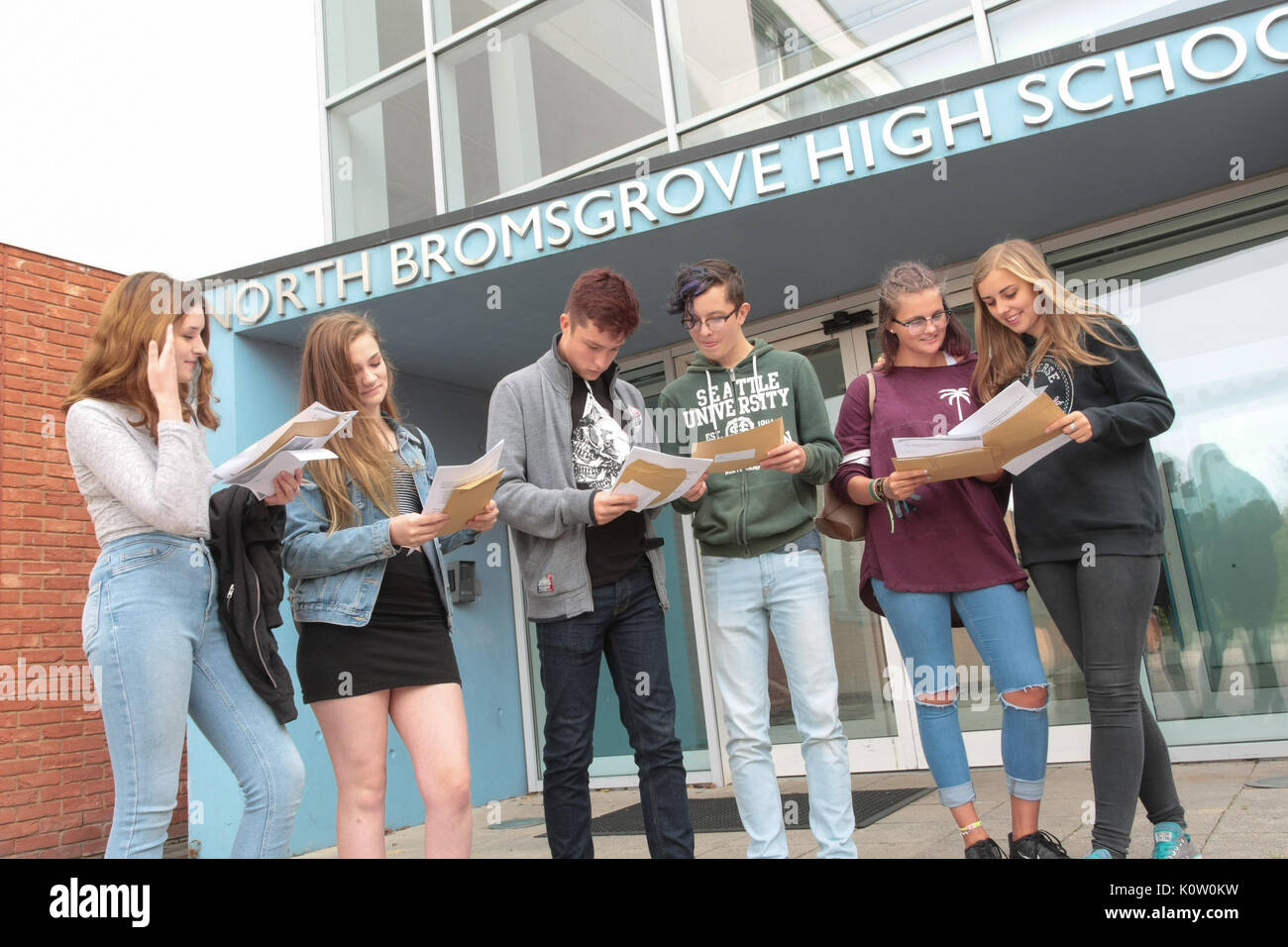 Teenagers opening their GCSE examination exam results UK Britain Stock Photo