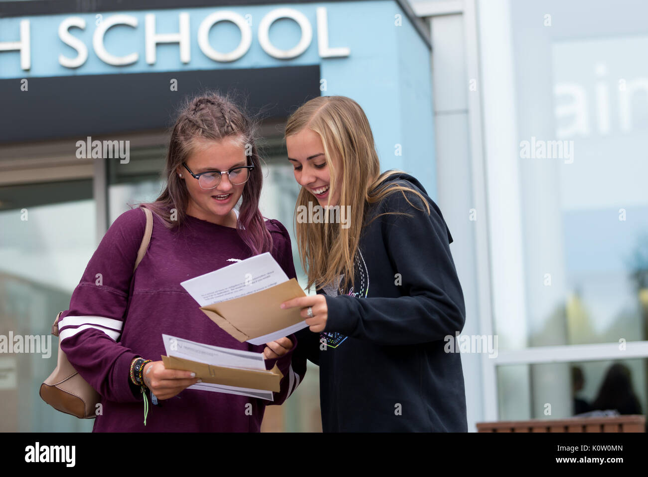 Two girls teenagers opening their GCSE examination exam results UK Britain Stock Photo