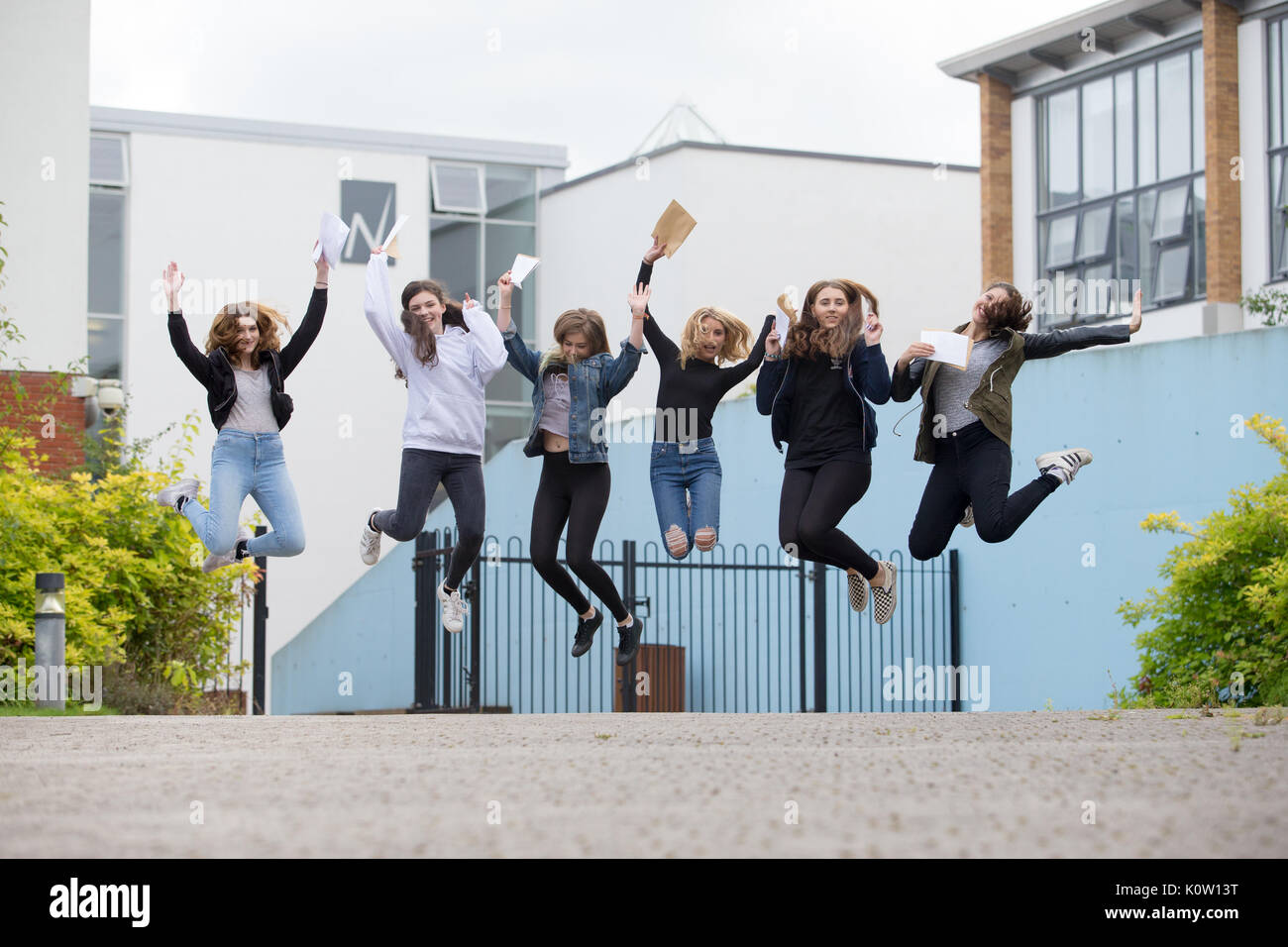 School pupils students jumping for joy having passed their GCSE exams at 16, Britain UK Stock Photo