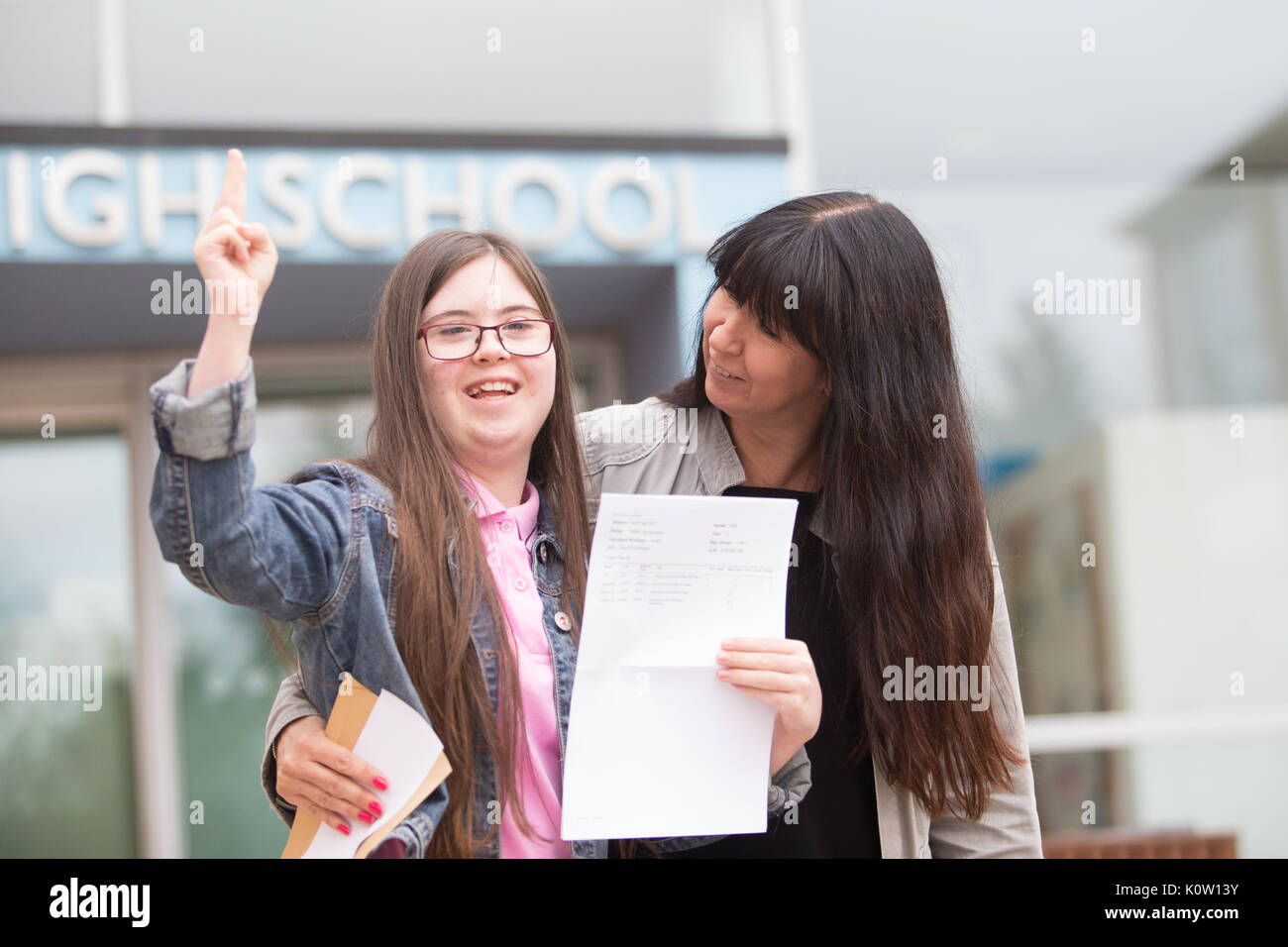 Young school leaver who has Down's Sysdrome opens her GCSE exam results outside her secondary school UK Stock Photo