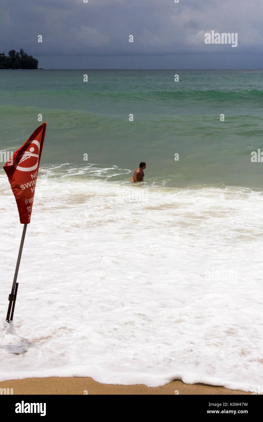 Kamala Beach, Phuket, Thailand. 24th Aug, 2017. A tourist swimming in a red no swimming zone. Many tourists ignore lifeguard warnings and no swimming zones resulting in several deaths per year in Phuket. Credit: kevin hellon/Alamy Live News Stock Photo
