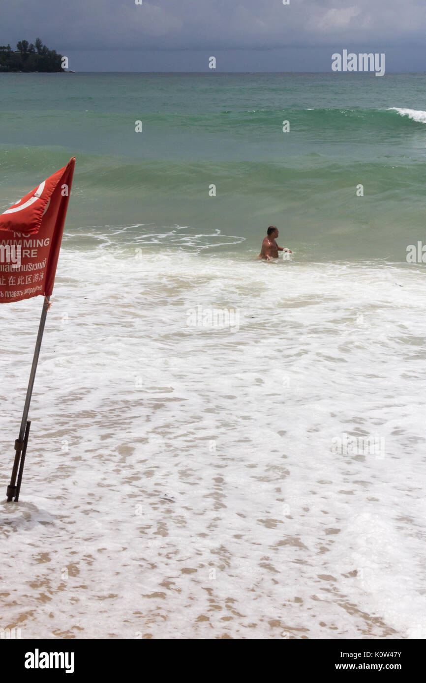 Kamala Beach, Phuket, Thailand. 24th Aug, 2017. A tourist swimming in a red no swimming zone. Many tourists ignore lifeguard warnings and no swimming zones resulting in several deaths per year in Phuket. Credit: kevin hellon/Alamy Live News Stock Photo