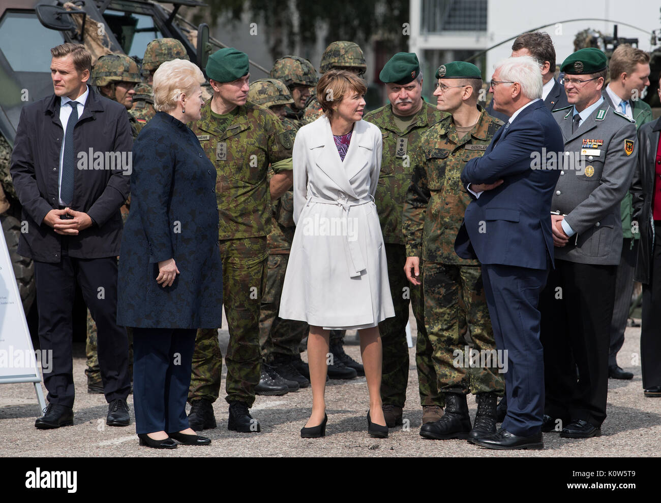 Rukla, Lithuania. 25th Aug, 2017. German President Frank-Walter Steinmeier, his wife Elke Buedenbender (C) and the President of the Republic of Lithuania, Dalia Grybauskaité (L), being shown around by Thorsten Gensler (3rd from right), Commander of NATO's Enhanced Forward Presence Bataillons, during a visit to the German-led NATO battalion in a military base in Rukla, Lithuania, 25 August 2017. President Steinmeier and his wife are on an official visit to the Baltic states between 22 and 25 August 2017. Photo: Bernd von Jutrczenka/dpa/Alamy Live News Stock Photo