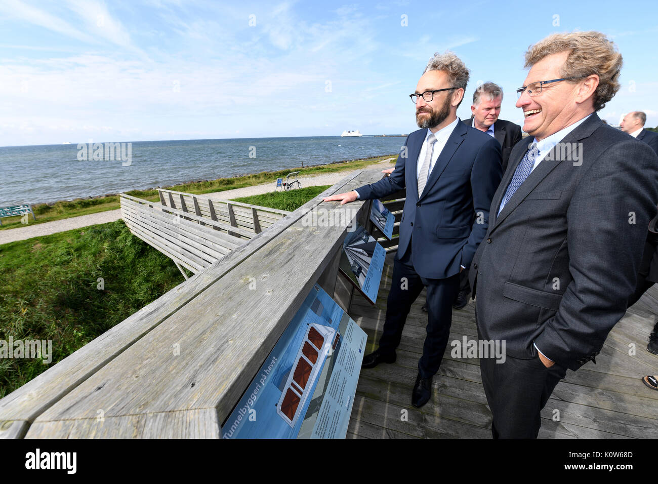 Denmark. 25th August, 2017. The Economy Minister of the state of Schleswig-Holstein, Bernd Buchholz (R), standing with his Danish counterpart Ole Birk Olesen (L) on a viewing platform of the proposed tunnel in Rødbyhavn, Denmark, 25 August 2017. The topic of the talks was the future Fehmarnbelt tunnel. Photo: Carsten Rehder/dpa/Alamy Live News Stock Photo