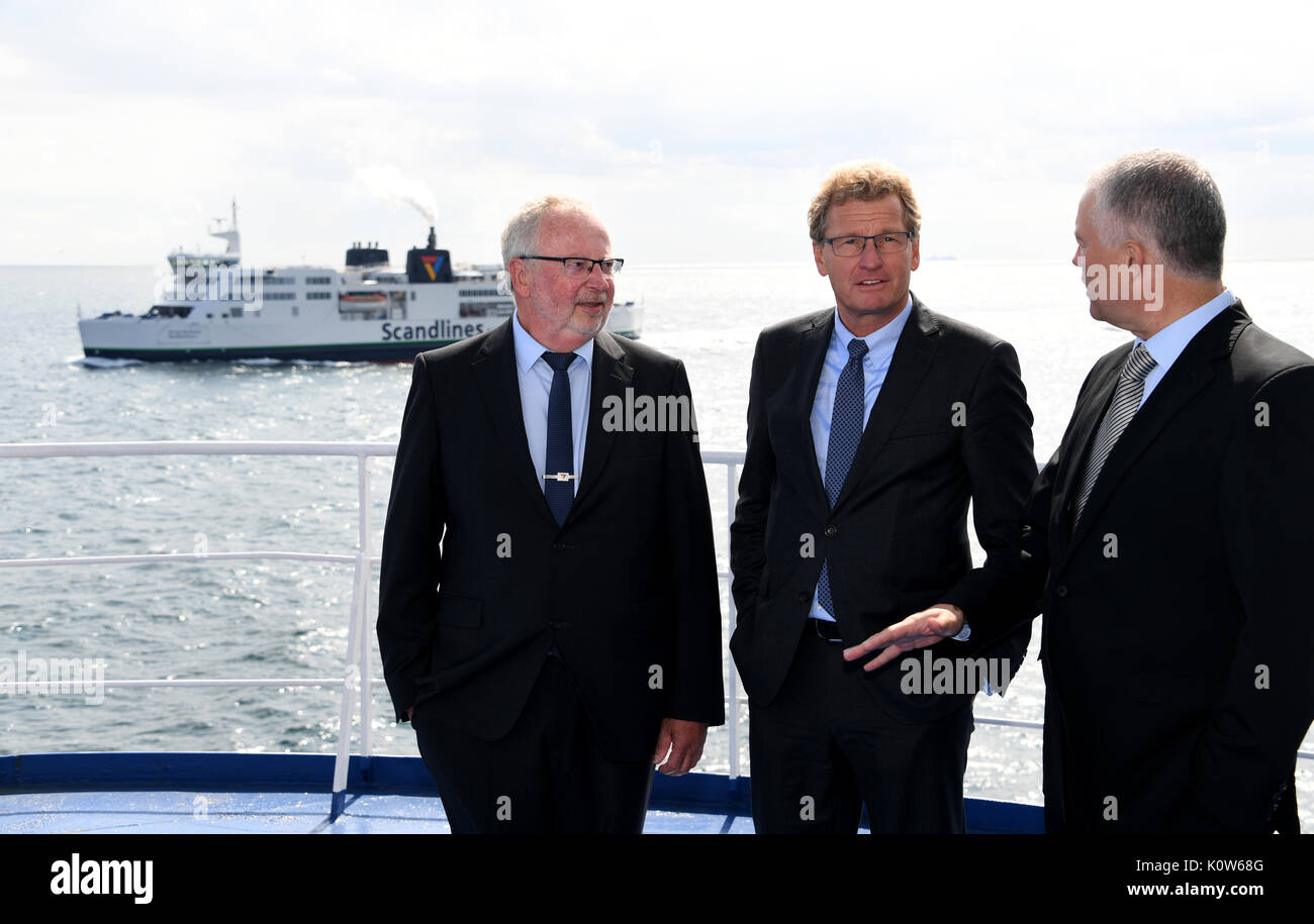 Denmark. 25th August, 2017. The Economy Minister of the state of Schleswig-Holstein, Bernd Buchholz (C), speaking with Senior Captain Johannes Wasmuth (L) and the head of the Scandline, Soren Paulsgaard, aboard the ferry 'Deutschland' traveling between Puttgarden, Germany and Rødbyhavn, Denmark, 25 August 2017. Buchholz had previously met with his Danish counterparts for talks on the Fehmarnbelt tunnel. Photo: Carsten Rehder/dpa/Alamy Live News Stock Photo