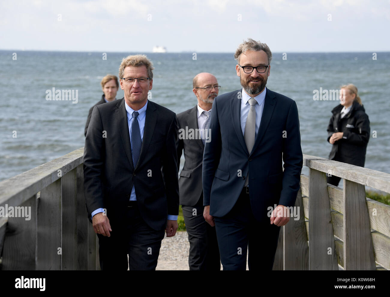Denmark. 25th August, 2017. The Economy Minister of the state of Schleswig-Holstein, Bernd Buchholz (L), standing with his Danish counterpart Ole Birk Olesen (R) on a viewing platform of the proposed tunnel in Rødbyhavn, Denmark, 25 August 2017. The topic of the talks was the future Fehmarnbelt tunnel. Photo: Carsten Rehder/dpa/Alamy Live News Stock Photo