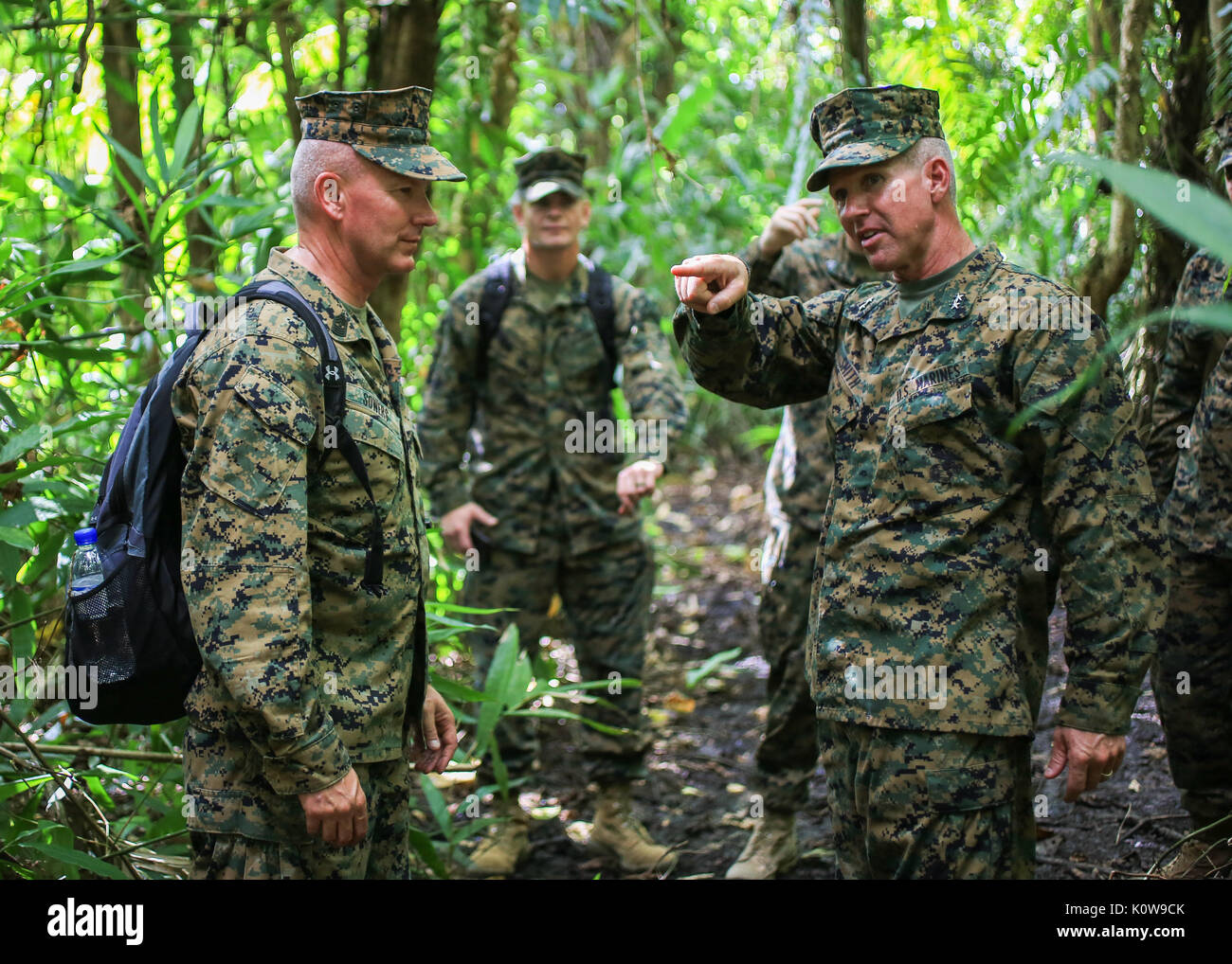 U.S. Marine Corps Maj. Gen. Eric M. Smith, commanding general, and Sgt. Maj. William T. Sowers, sergeant major, both with 1st Marine Division, hike to Gunnery Sgt. John Basilone's fighting hole during a tour of Bloody Ridge in Guadalcanal, Solomon Islands, Aug. 9, 2017. The tour was used to teach the Marines about Bloody Ridge and the Battle of Guadalcanal, which took place from Aug. 7, 1942 to Feb. 9, 1943. (U.S. Marine Corps photo by Sgt. Wesley Timm) Stock Photo