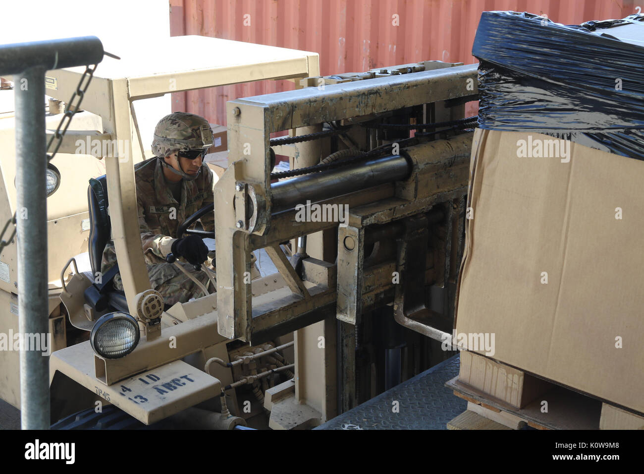 Spc. Gabriel Torres, an automated logistical specialist for Company A, 64th Brigade Support Battalion, 3rd Armored Brigade Combat Team, 4th Infantry Division, uses a forklift to move supplies for a resupply mission at Grafenwoehr Training Area, Germany, Aug. 15, 2017. The BSB is the key supplier for 3rd ABCT battalions providing a persistent presence across eastern Europe to deter aggression against NATO Allies and partners. (U.S. Army photo by Staff Sgt. Ange Desinor, 3rd Armored Brigade Combat Team, 4th Infantry Division) Stock Photo