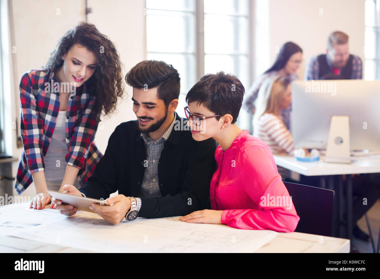 Group of young architects using digital tablet Stock Photo