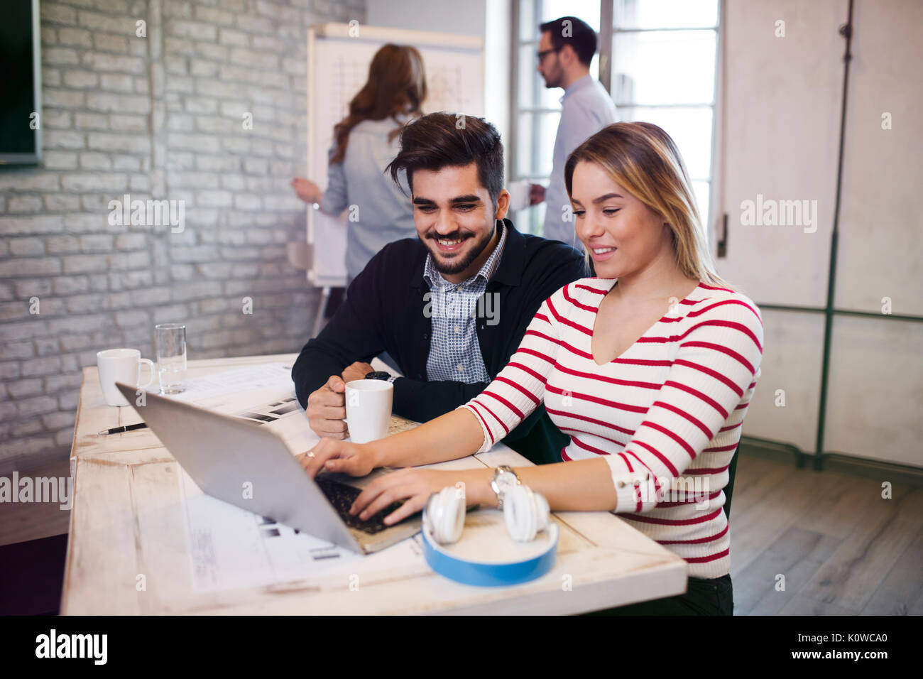 Two young perspective architects working on laptop Stock Photo
