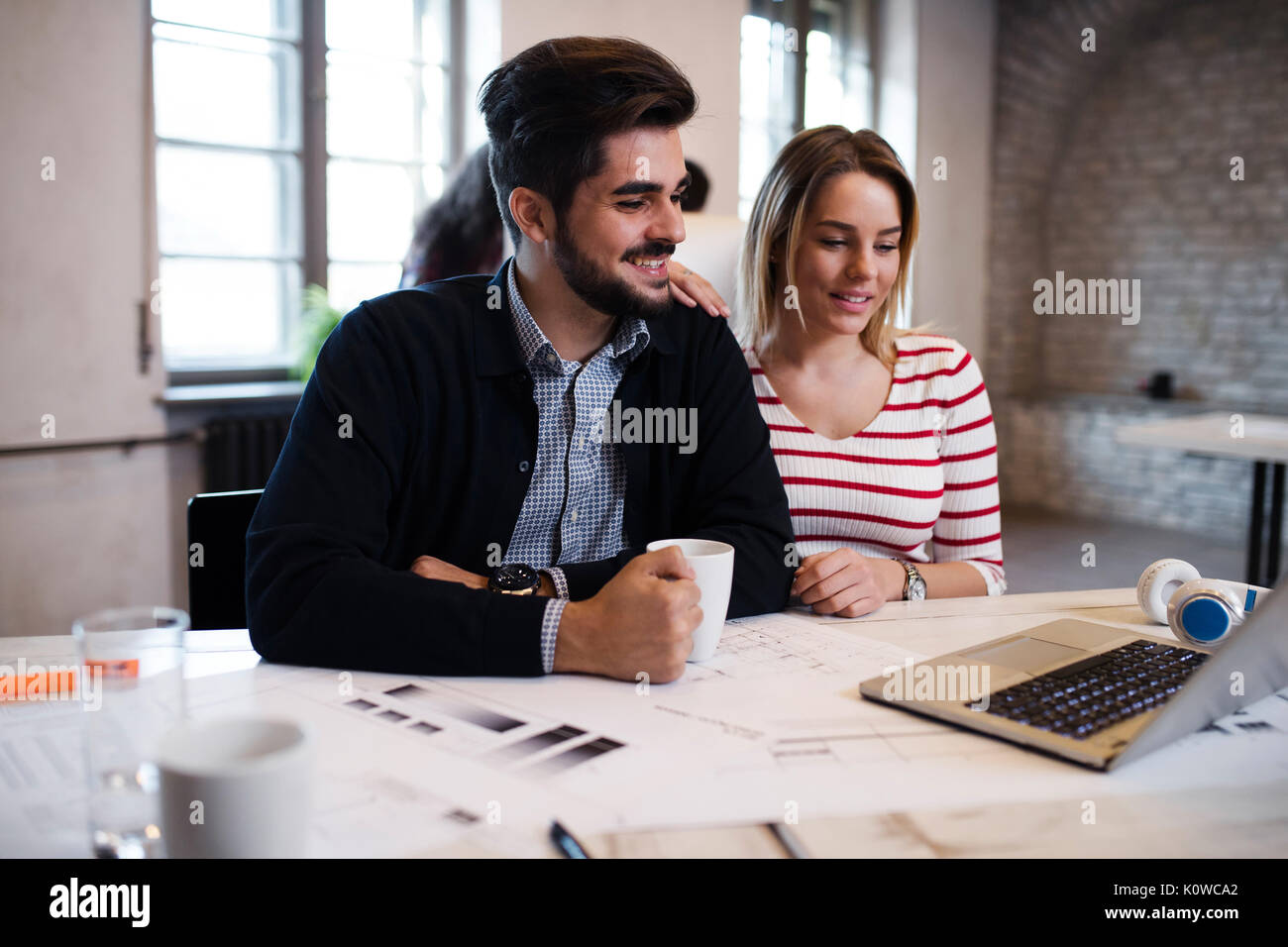 Two young perspective architects working on laptop Stock Photo