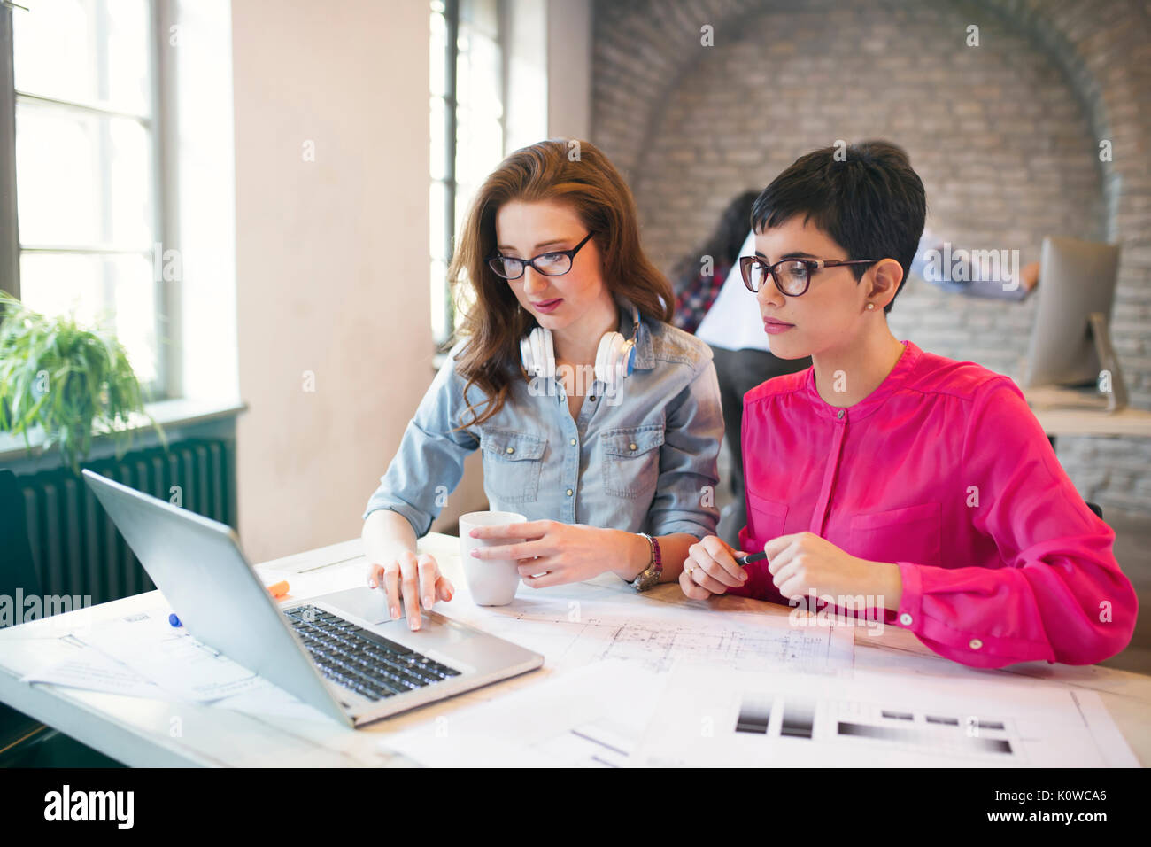 Two young perspective architects working on laptop Stock Photo