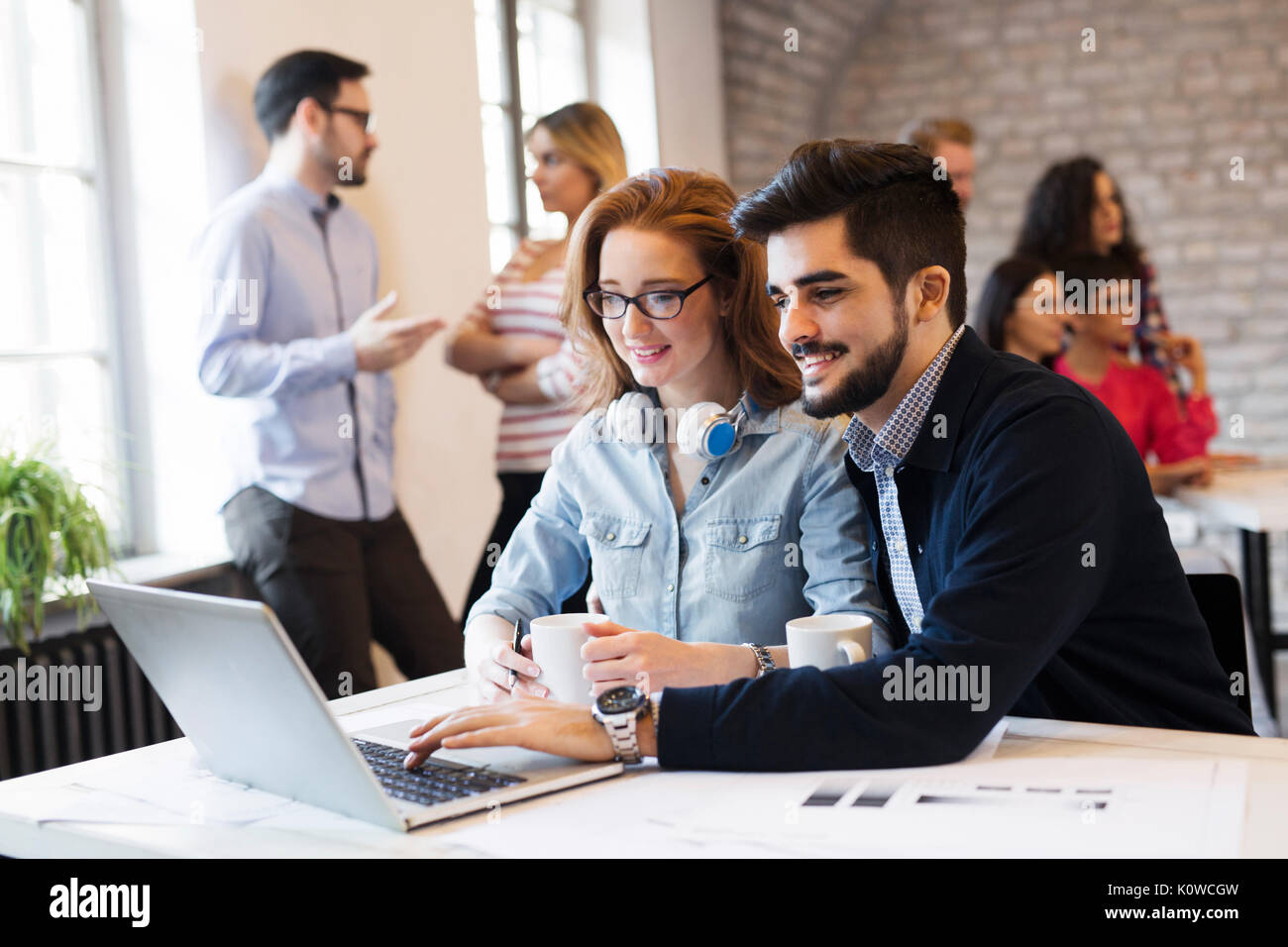Two young architects working on laptop in office Stock Photo