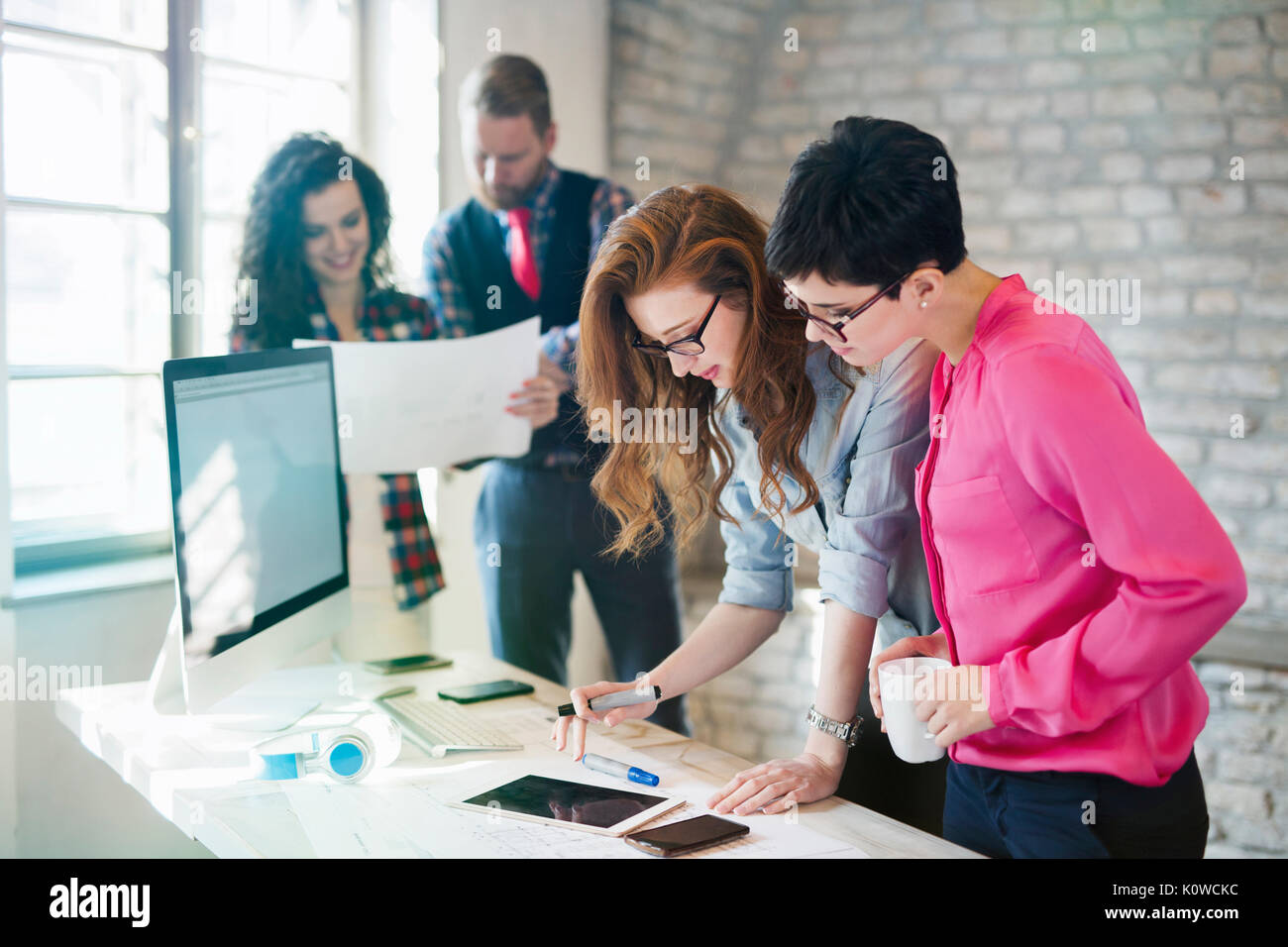 Group of young architects using digital tablet Stock Photo