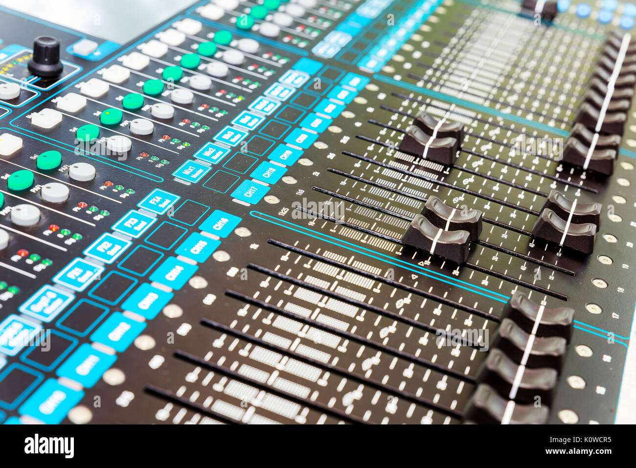 Professional audio mixing console closeup with adjusting knobs, buttons ...