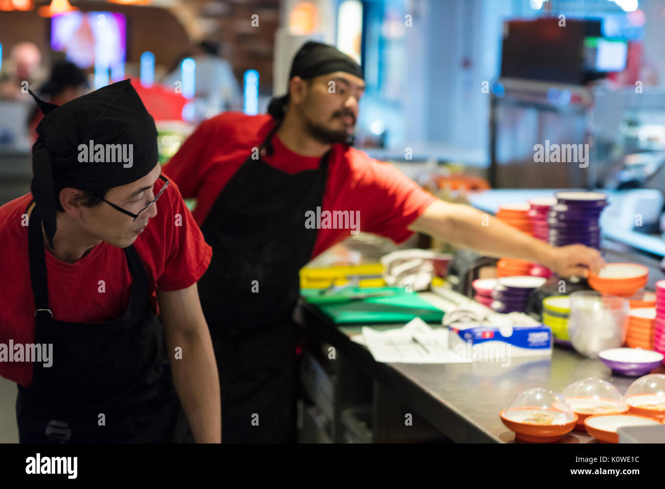 Busy production of sushi in Japanese restaurant Stock Photo