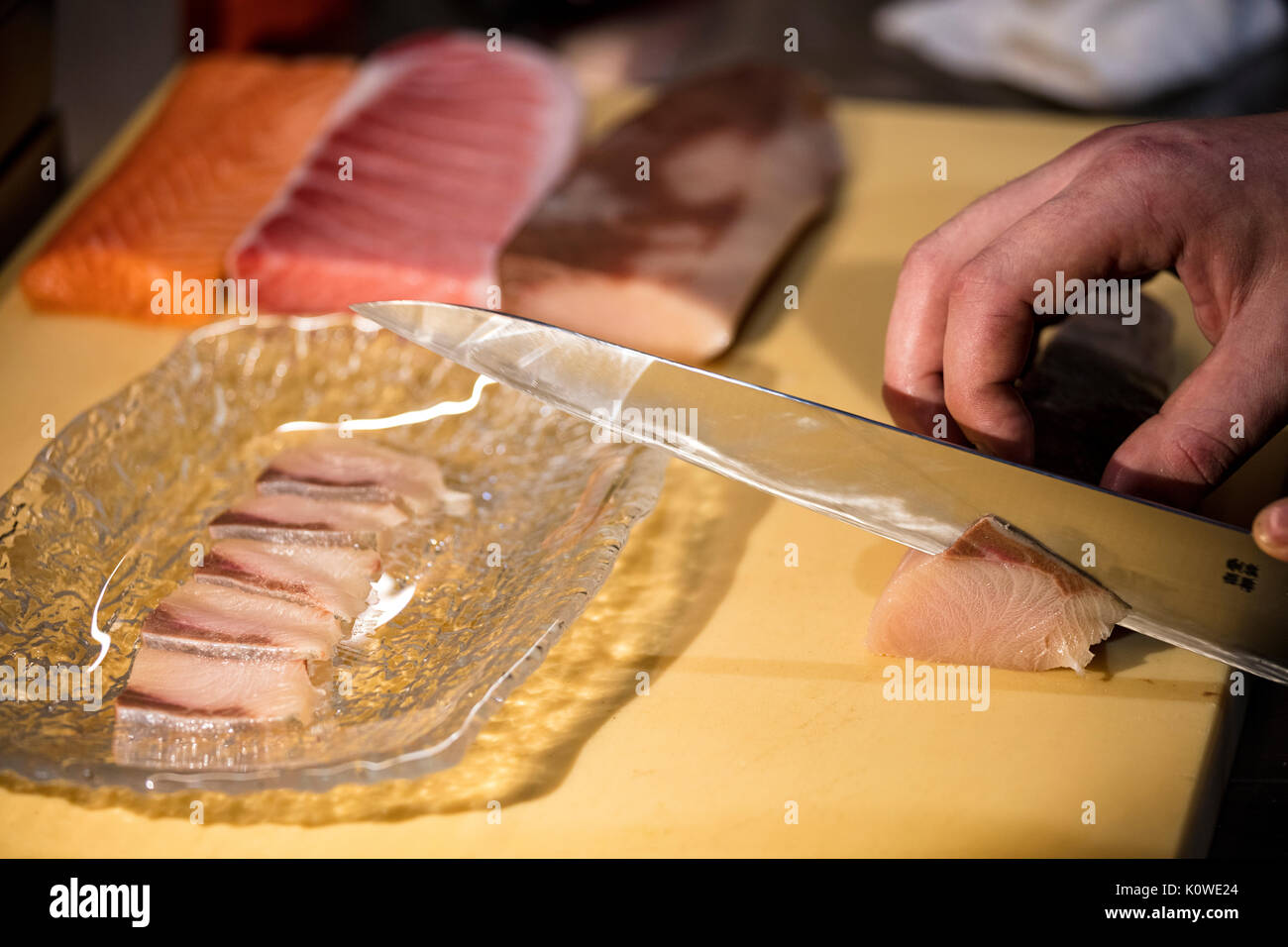 Cutting sushi to make nigiri Stock Photo
