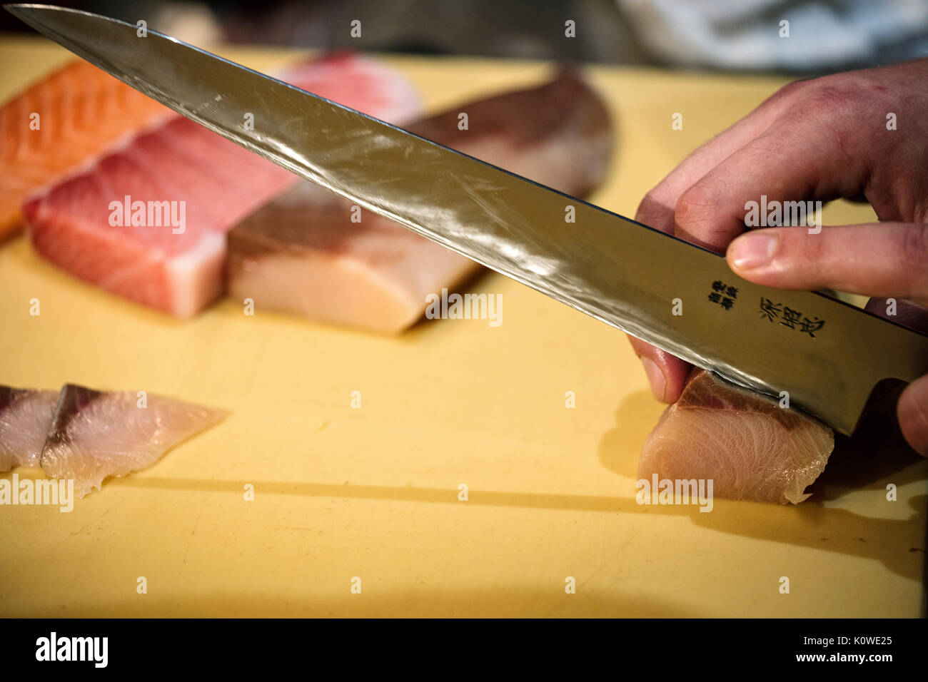 Cutting sushi to make nigiri Stock Photo