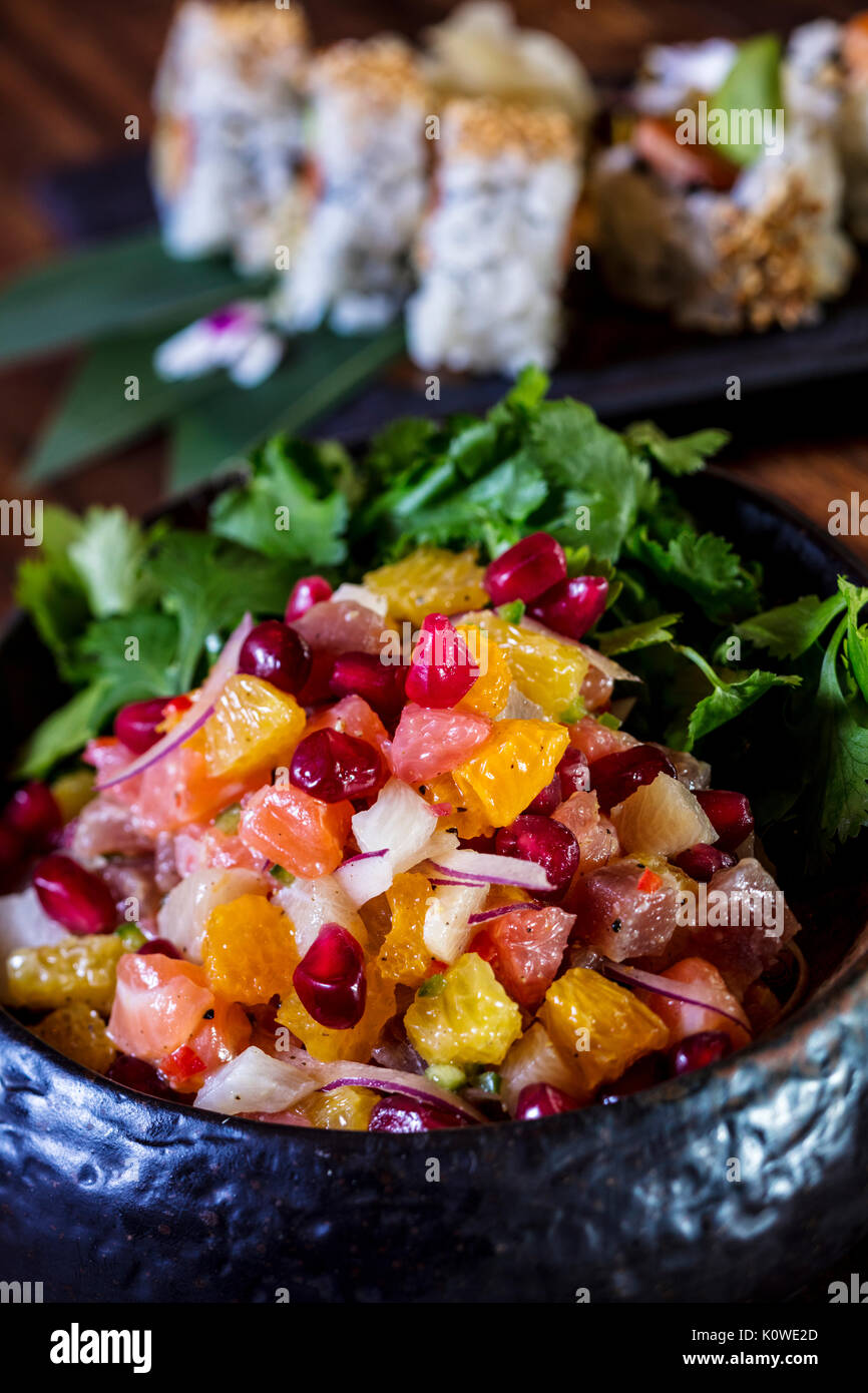 Luxury fruit salad with sushi in background Stock Photo