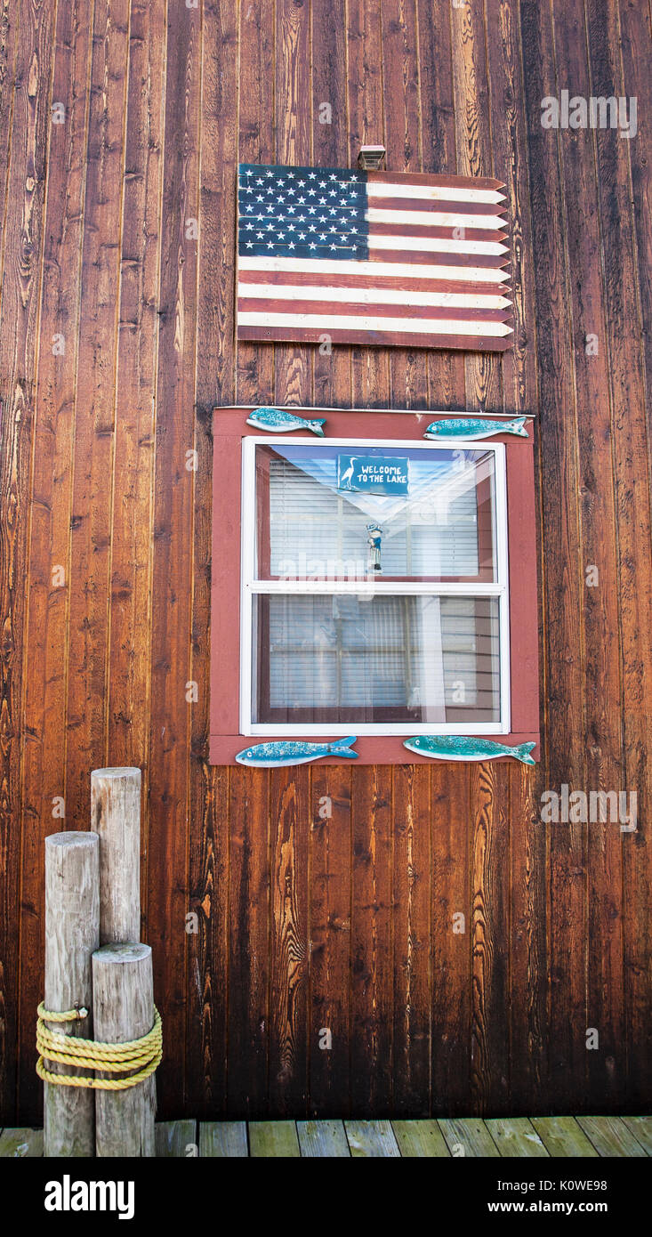 American flag and window of a vintage boathouse on the Canandaigua City