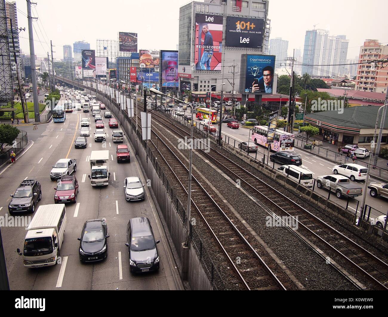 MANDALUYONG CITY, PHILIPPINES - AUGUST 18, 2017: Private and public vehicles passing along EDSA and the Boni MRT Station in Mandaluyong City, Philippi Stock Photo