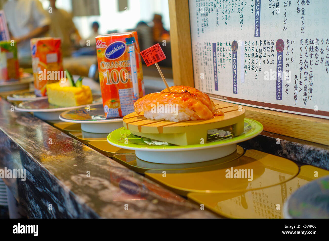 TOKYO, JAPAN -28 JUN 2017: Close up of assorted japanesse food over a table, inside of a kaitenzushi conveyor belt sushi restaurant in Tokyo Stock Photo