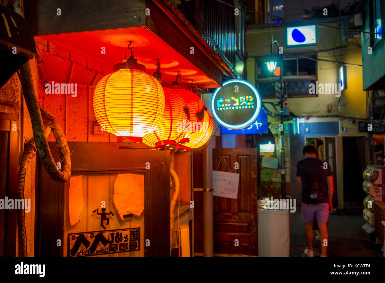 TOKYO, JAPAN JUNE 28 - 2017: Red lanterns with Japanesse letters at night in traditional back street bars in Shinjuku Golden Gai. Golden gai consists of 6 tiny alleys with 200 tiny bars and 20th century atmosphere, located in Tokyo Stock Photo