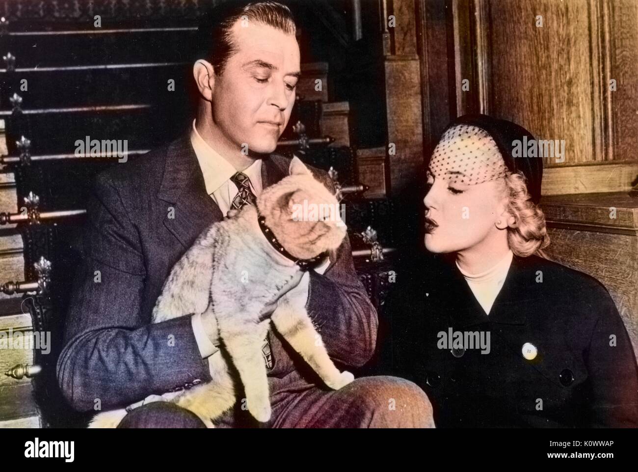 Ray Milland and Jan Sterling with Rhubarb, a cat, 1968. Note: Image has been digitally colorized using a modern process. Colors may not be period-accurate. Stock Photo