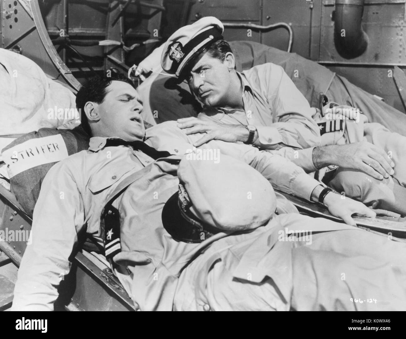 Two soldiers on stretchers, one appearing to be wounded, the second comforting him, wearing military uniforms, in a film still from an unidentified Hollywood war movie, Hollywood, California, 1953. Photo credit Smith Collection/Gado/Getty Images. Stock Photo