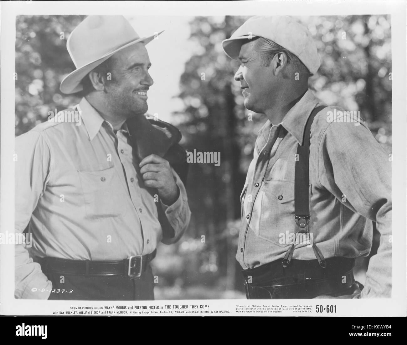 Wayne Morris and Preston Foster in overalls and cowboy hats in a film still from The Tougher They Come, 1935. Photo credit Smith Collection/Gado/Getty Images. Stock Photo