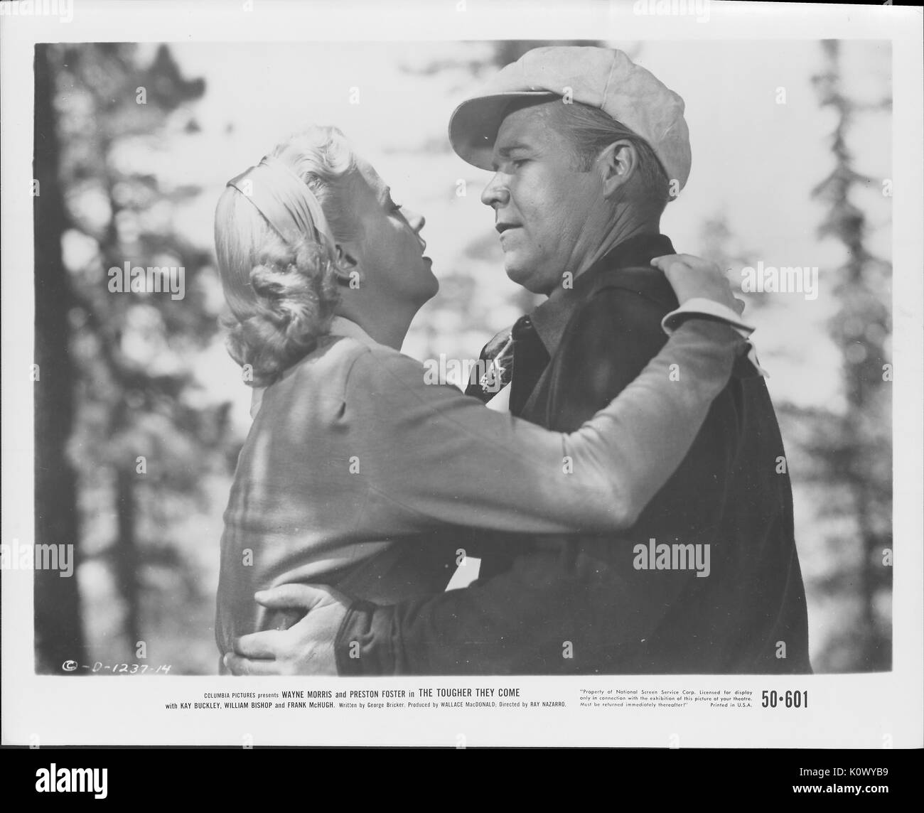 A movie still scene from 'The Tougher They Come' (1950 Columbia Pictures film), showing a man and a woman holding on to each other, with the woman looking up to her man as she says something serious to him, 1950. Stock Photo