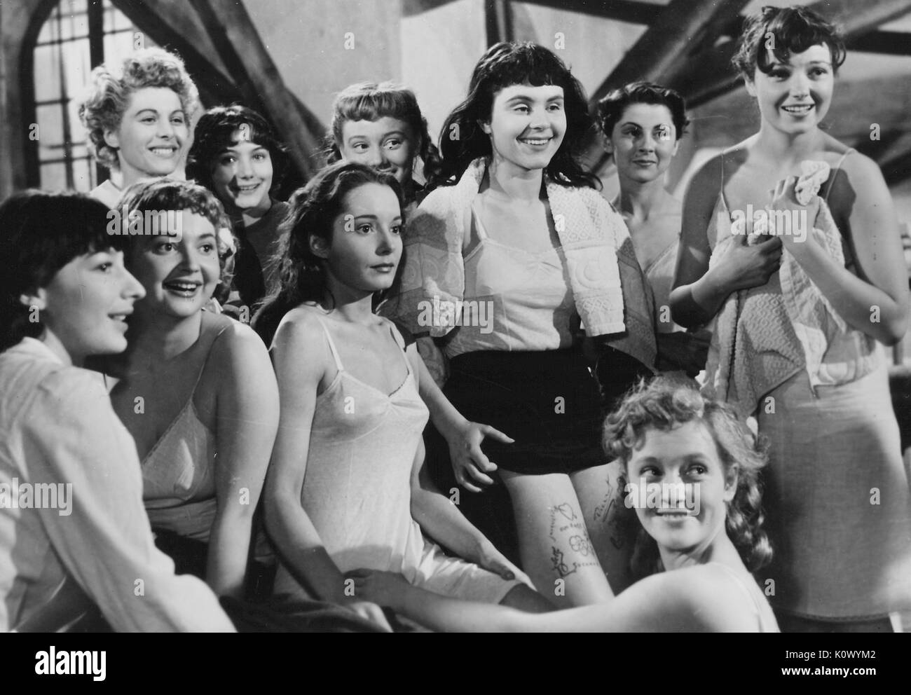 Au Royaume Des Cieux (In the Kingdom of Heaven), movie still depicting girls in pajamas standing in a group and looking off screen, one girl with an apprehensive facial expression, from the film noir movie by director Julien Duvivier, which tells the story of girls in a female reformatory who are persecuted by a sadistic head warden, and who attempt to escape with the help of the heroines lover, played by Serge Reggiani, 1949. Stock Photo