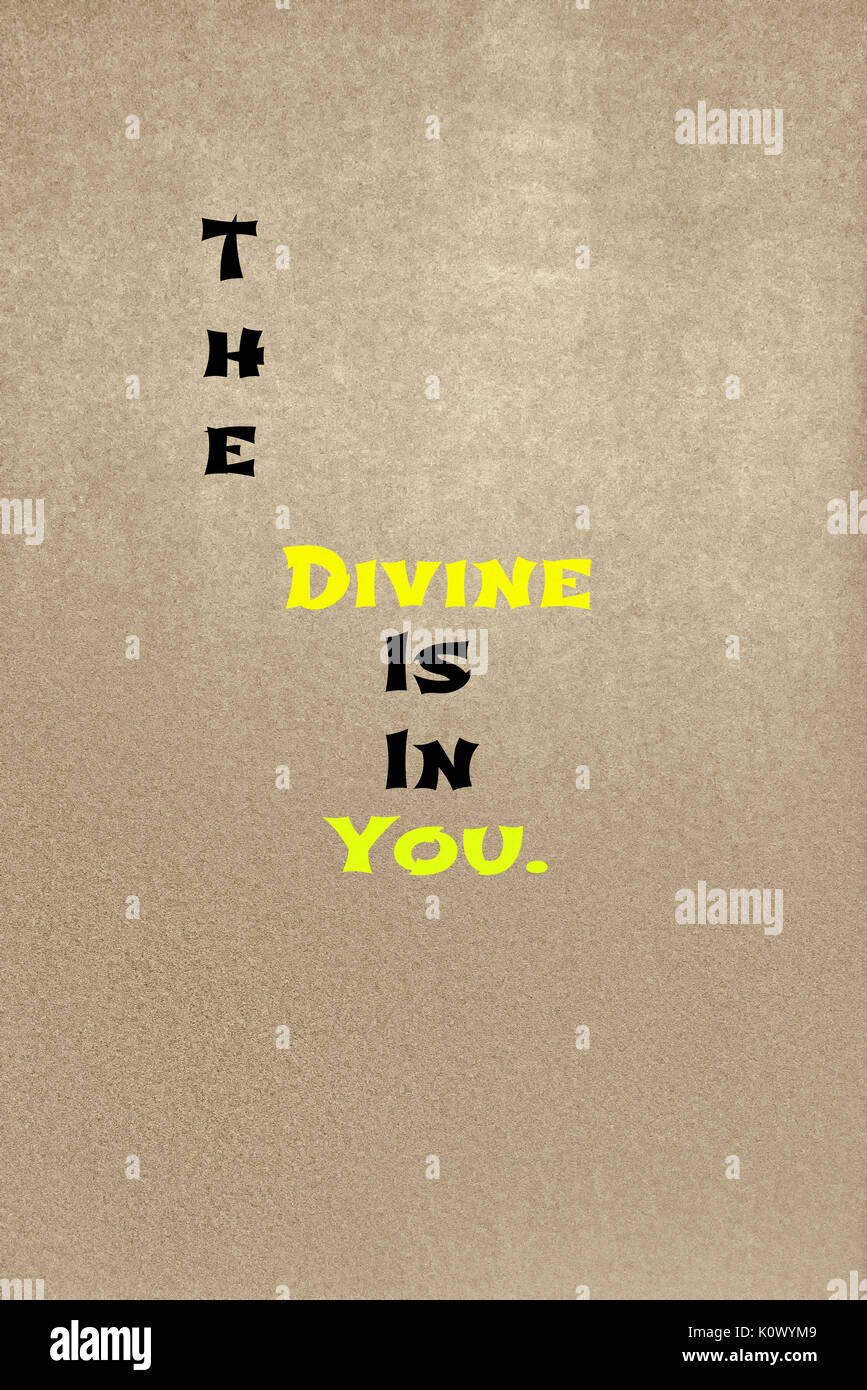 The phrase The Divine Is In You placed onto a chalkboard texture background.  Graphic Design. Stock Photo