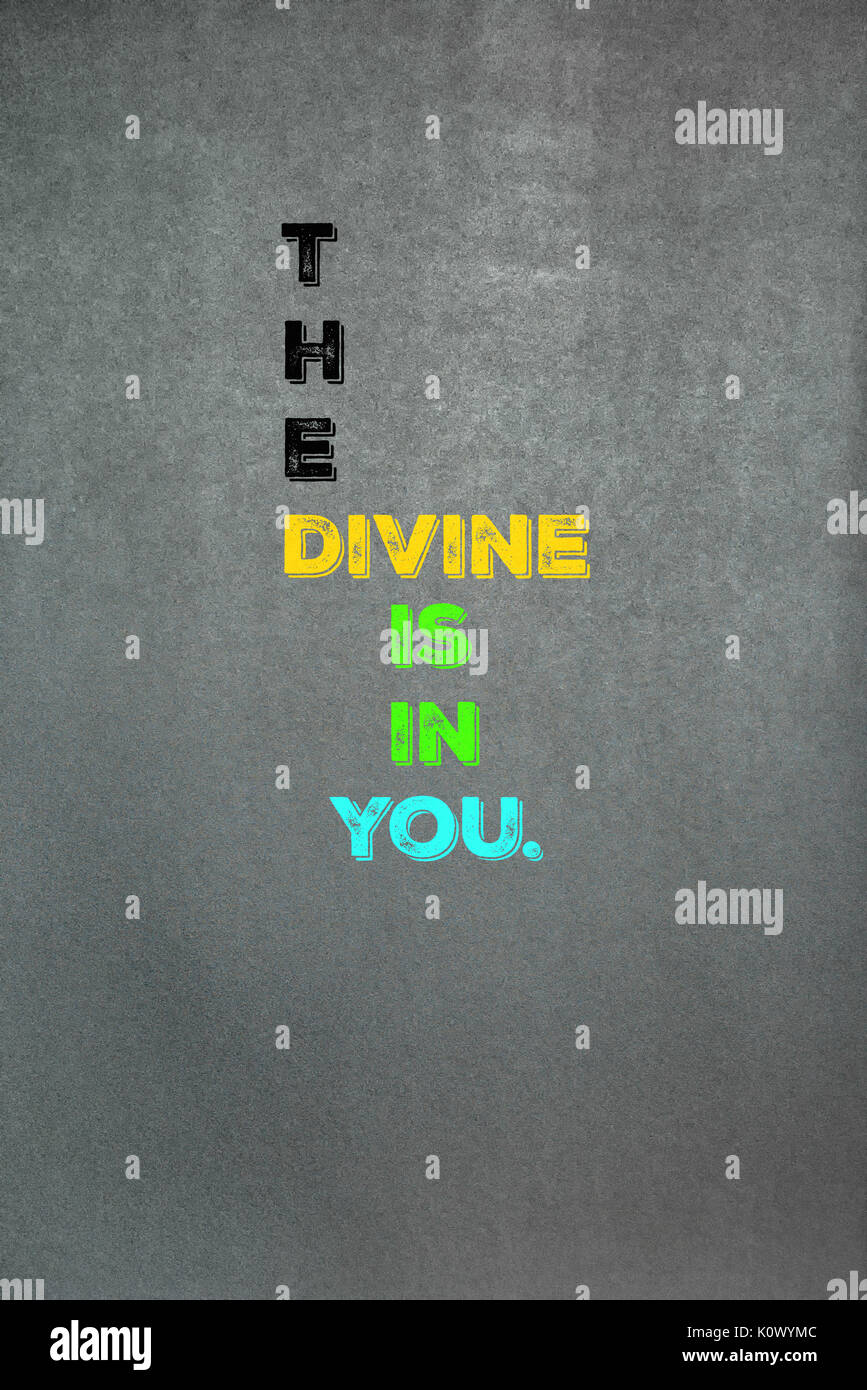 The phrase The Divine Is In You placed onto a chalkboard texture background.  Graphic Design. Stock Photo