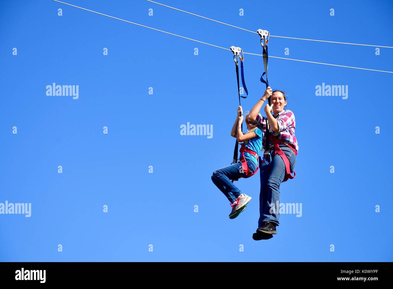 Mother and young daughter on a zip line Stock Photo Alamy