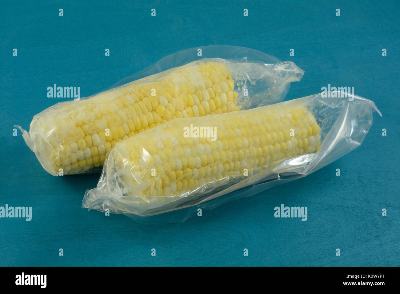 Two ears of corn in airtight plastic packaging to preserve freshness Stock Photo