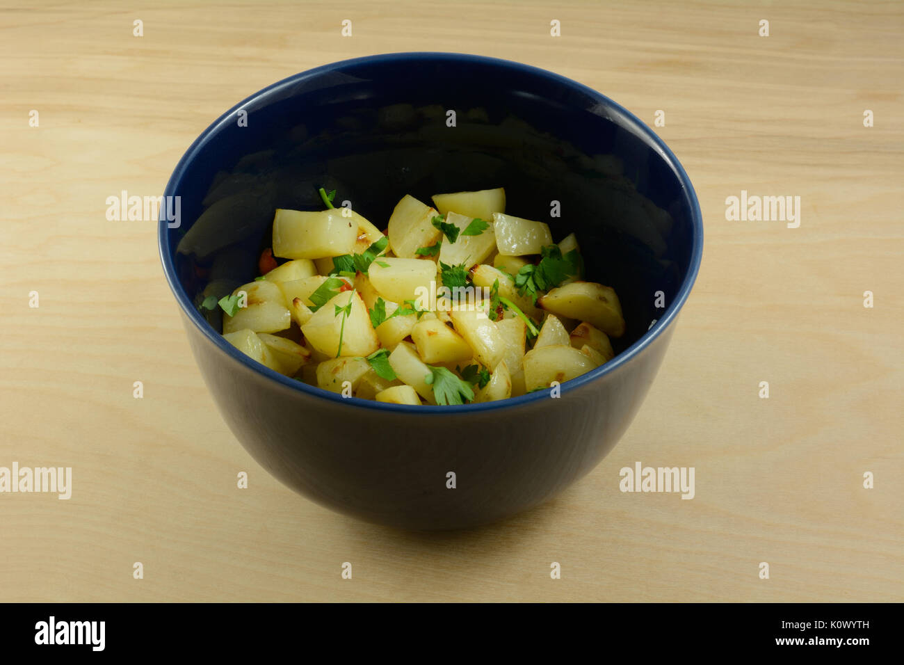 Homemade low calorie potato and carrot salad side dish in blue bowl on