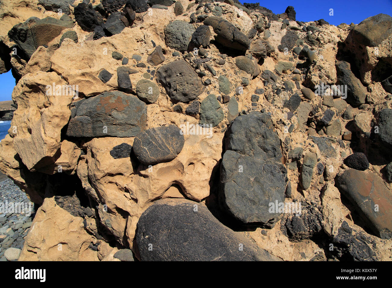 Conglomerate rock with volcanic bombs embedded in sediment, Playa de Garcey, Fuerteventura, Canary Islands, Spain Stock Photo