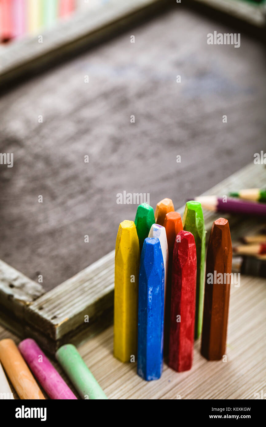 School objects for students. Chalkboard, pencils, crayons and apple