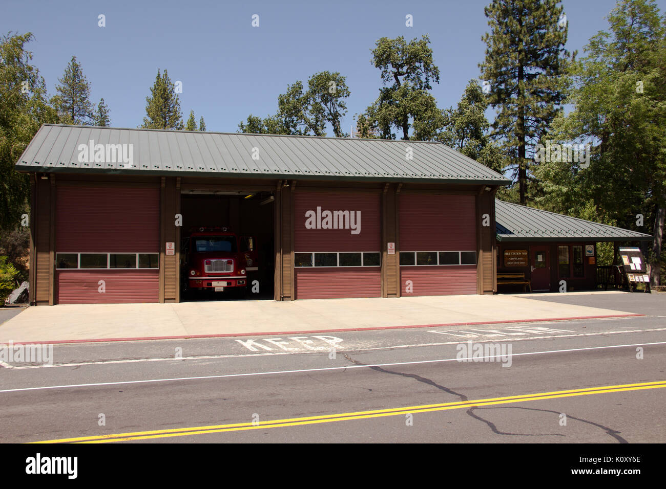 A fire station in Groveland, CA, With a red fire engine stationed inside Stock Photo