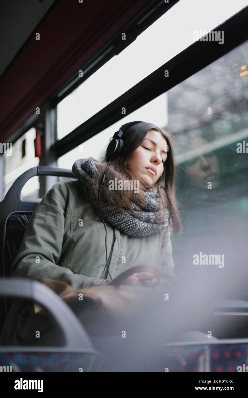 Girl with headphones on the bus Stock Photo