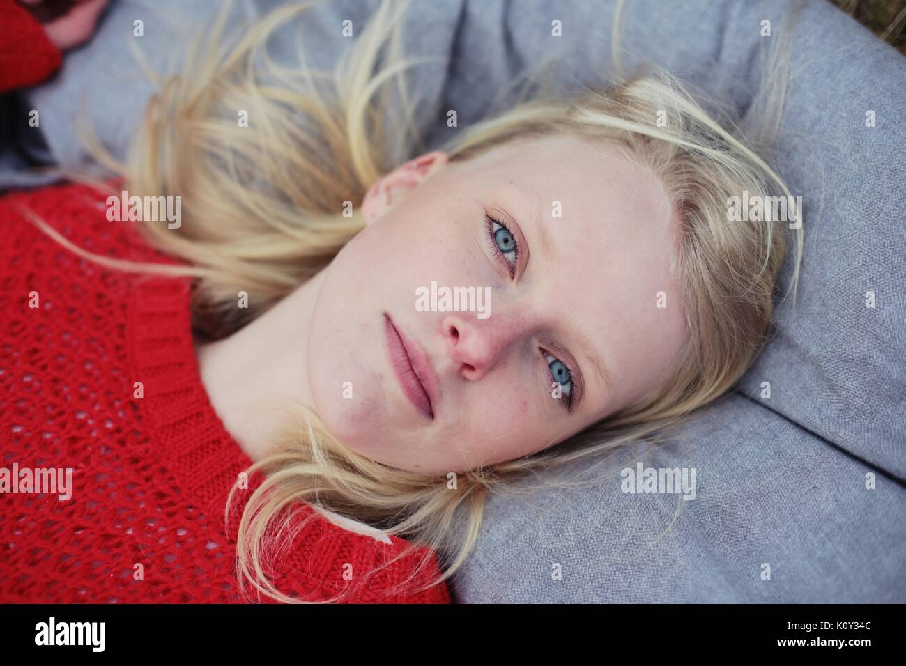 Blonde woman lies on a pillow Stock Photo