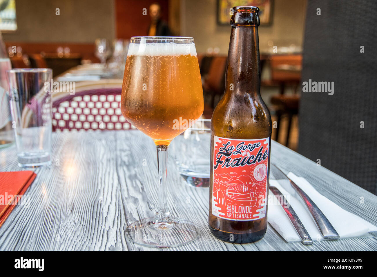 Still life in a restaurant with a bottle of La Gorge Frauche, a craft beer from Beziers, France Stock Photo