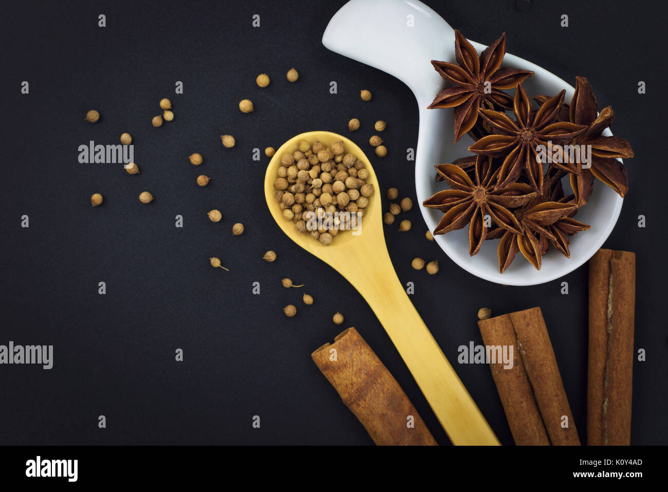 Star Anise and Spices coriander seeds, cumin seeds, cinnamon on black