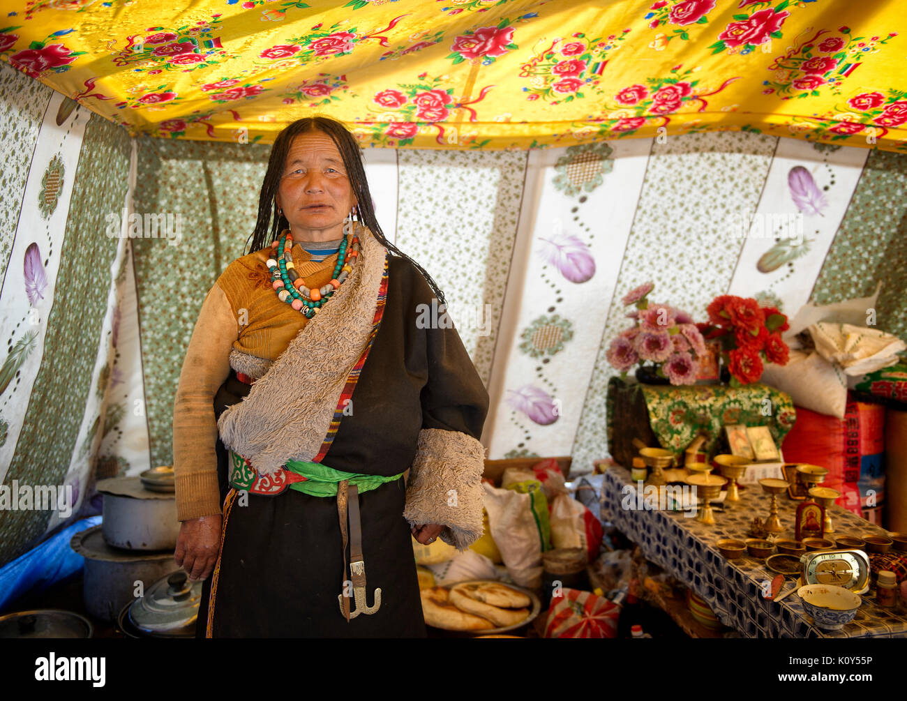 After a long day of work, tibetan nomads rest in their tent, cook and chat Stock Photo