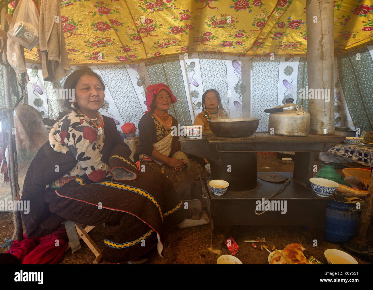 Tibetan nomads cooking and resting in their tent. tibetan plateau Stock Photo