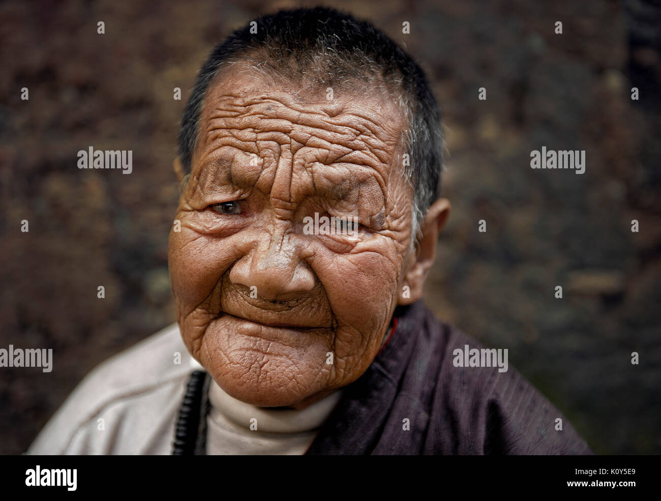 Traces of harshness in Tibetan faces. Kasongdu village Stock Photo