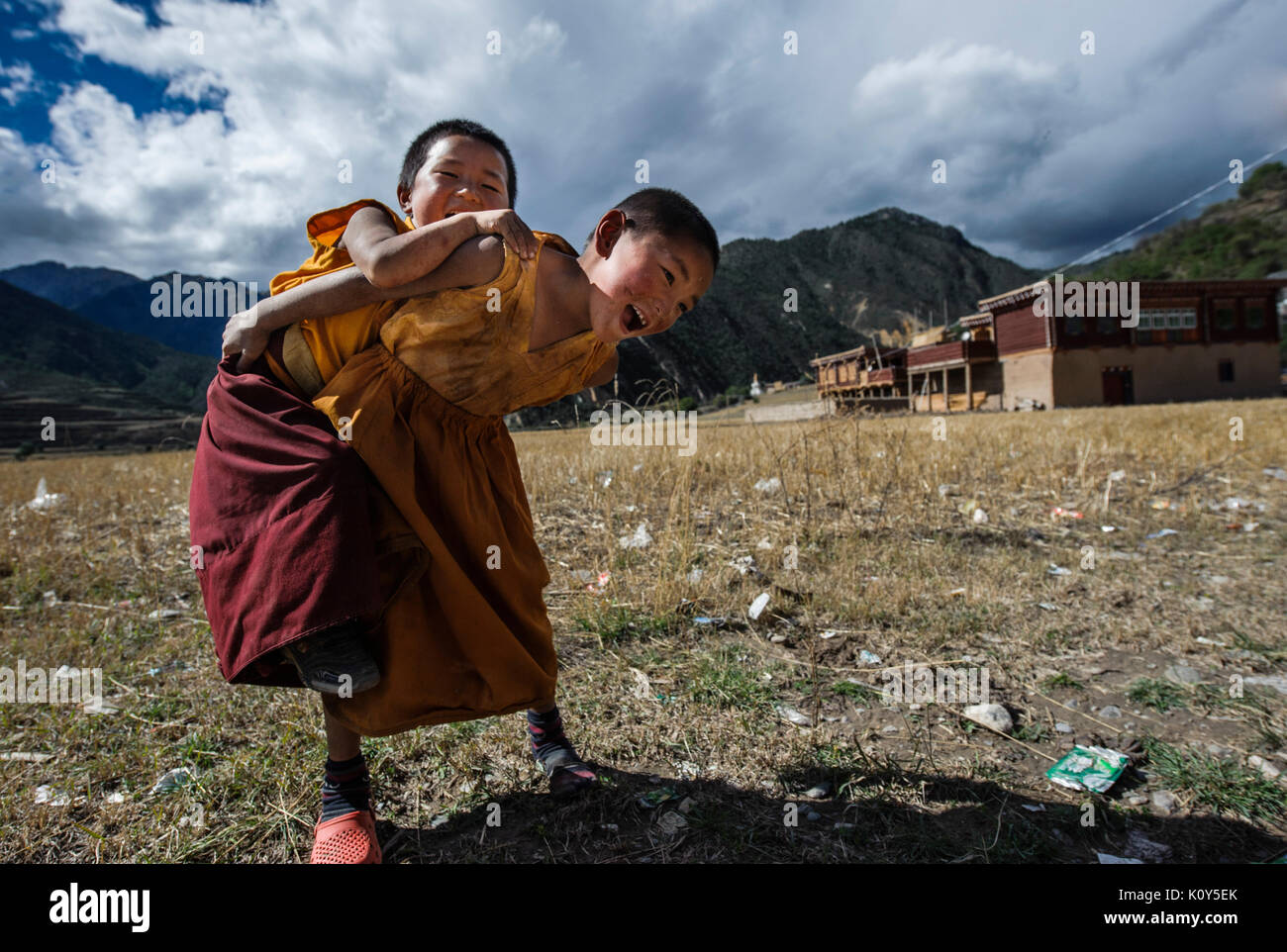 Young Tibetan buddhist monks play at their monastery Stock Photo