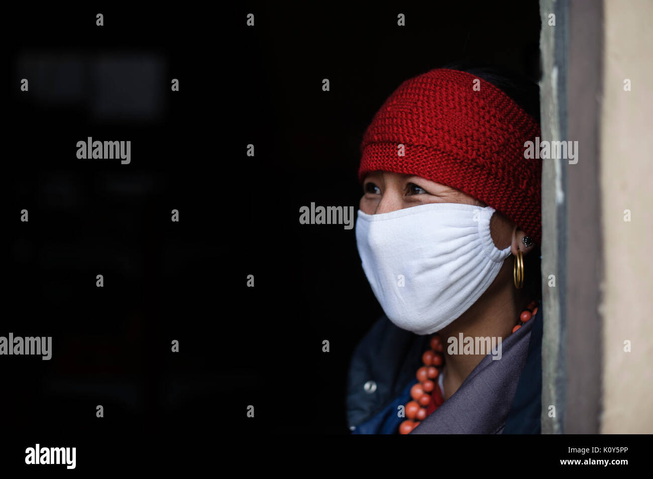 Tibetan woman wearing surgical mask, Tibetan Plateau Stock Photo