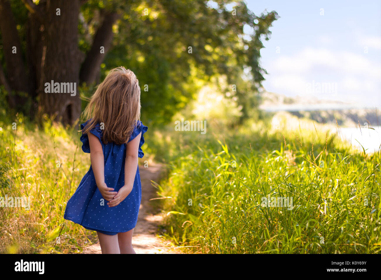 little girl goes on summer forest path along the river Stock Photo - Alamy